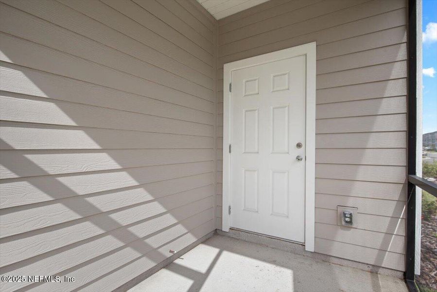 Exterior details and patio area of a home in Hardwick Farms: Hardwick Farms - Townhome Collection, Jacksonville (Image 25).