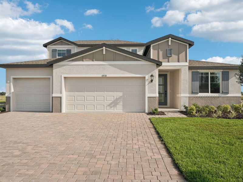 Front exterior of a new home in Oakfield Trails - Signature Series, Parrish, FL, highlighting curb appeal (Image 1). Front exterior of a new home in Oakfield Trails - Signature Series, Parrish, FL, highlighting curb appeal (Image 1).