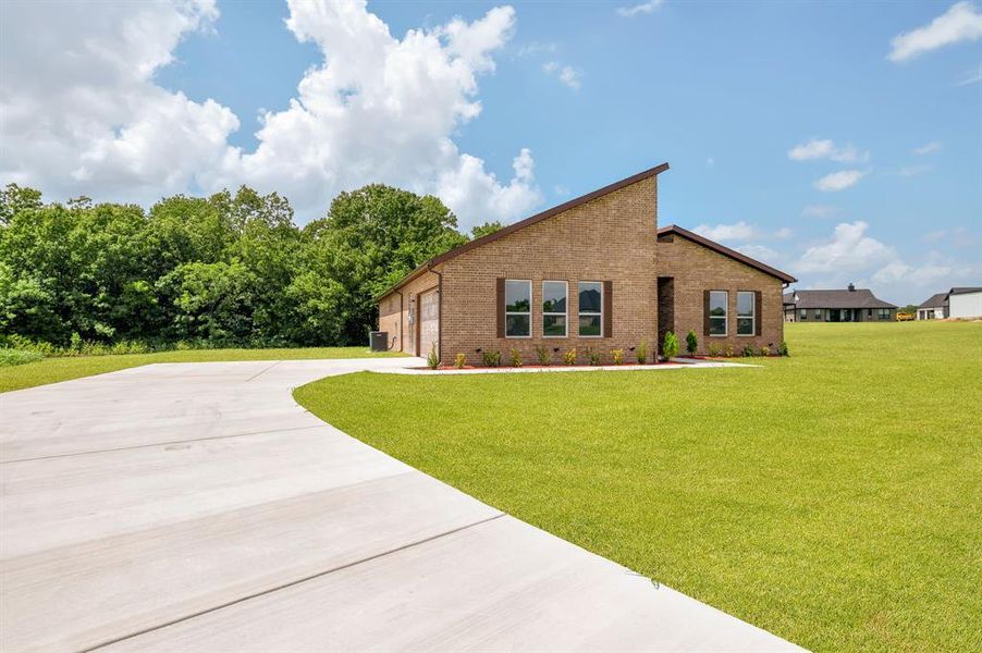 Brick exterior residence featuring a contemporary roofline and dark window shutters Brick exterior residence featuring a contemporary roofline and dark window shutters