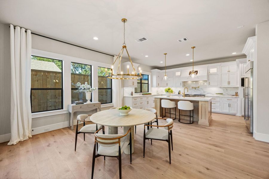 Breakfast Area sits in front of Chef's Gourmet Kitchen w/ a multitude of windows providing natural light.