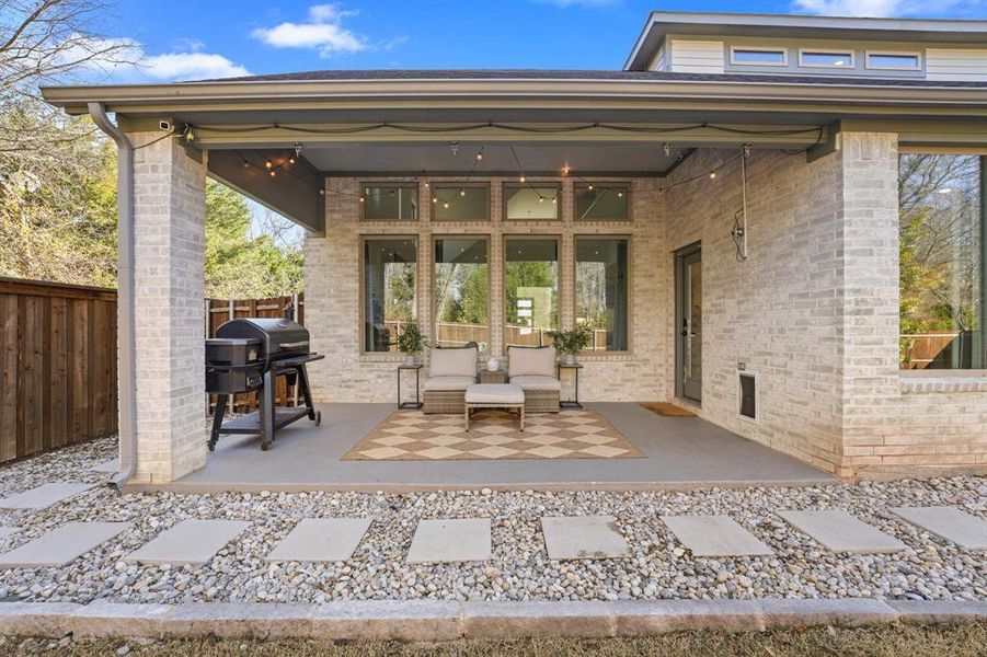 View of patio with a grill