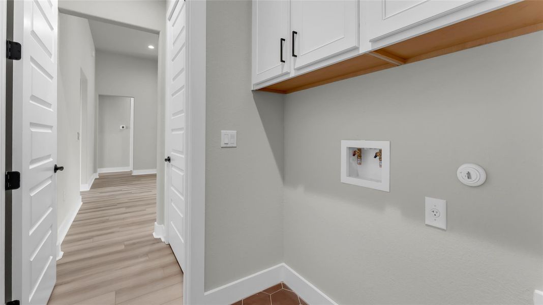 Laundry area featuring cabinet space, hookup for a washing machine, recessed lighting, and light wood finished floors