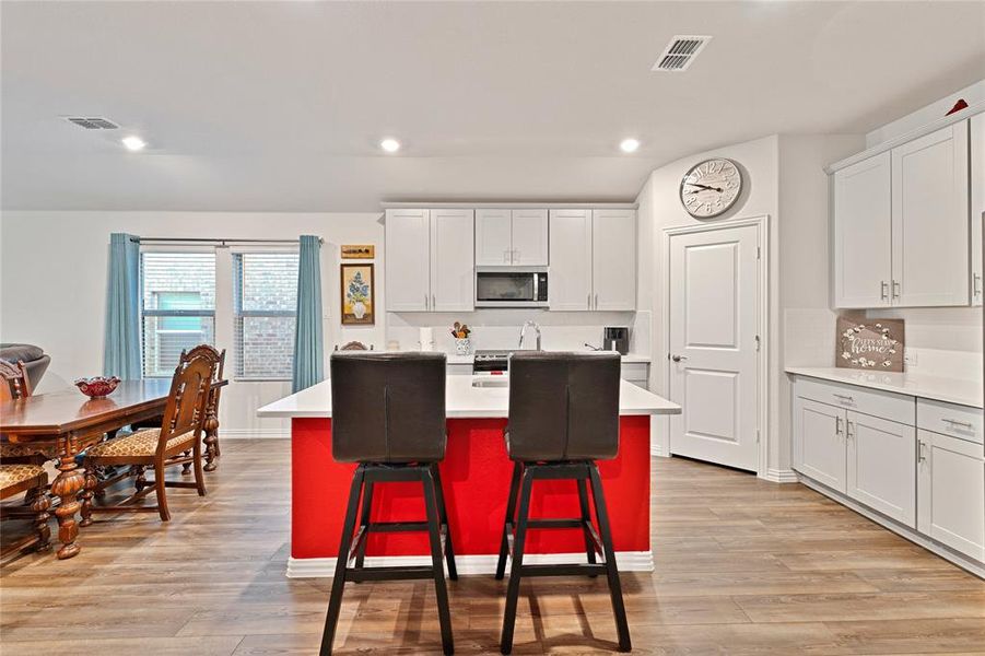 Kitchen with visible vents, appliances with stainless steel finishes, light countertops, and light wood finished floors