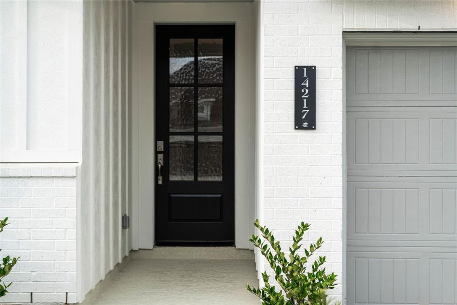 As you walk up to this beautiful home, the white-painted brickwork and black door are a beautiful contrast and exhibits strong curb appeal. The contemporary front door is highlighted with gorgeous glass panels that bring in the natural light into the foyer.