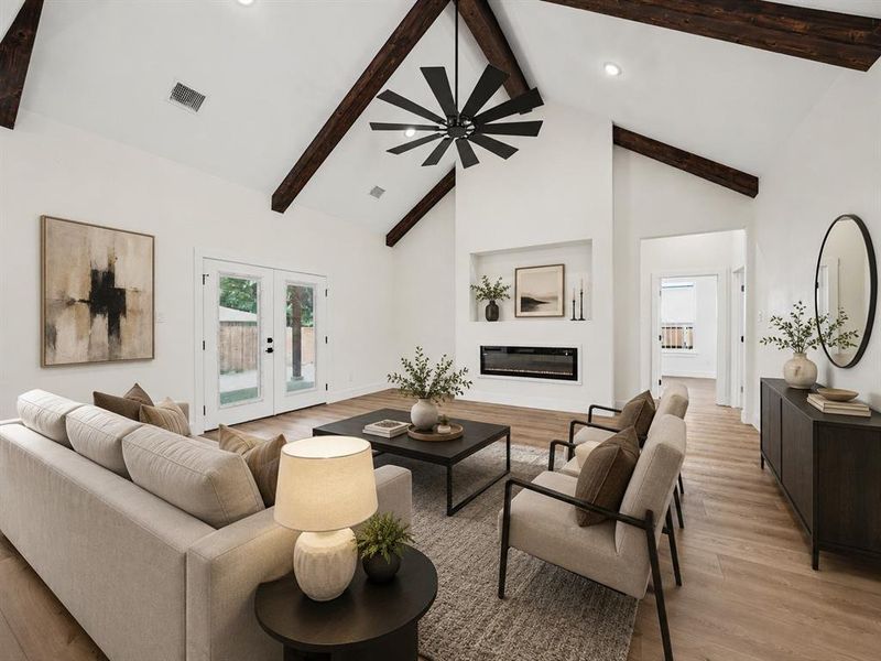Vaulted ceiling featuring exposed wood beams, recessed lighting, and a modern ceiling fan Vaulted ceiling featuring exposed wood beams, recessed lighting, and a modern ceiling fan
