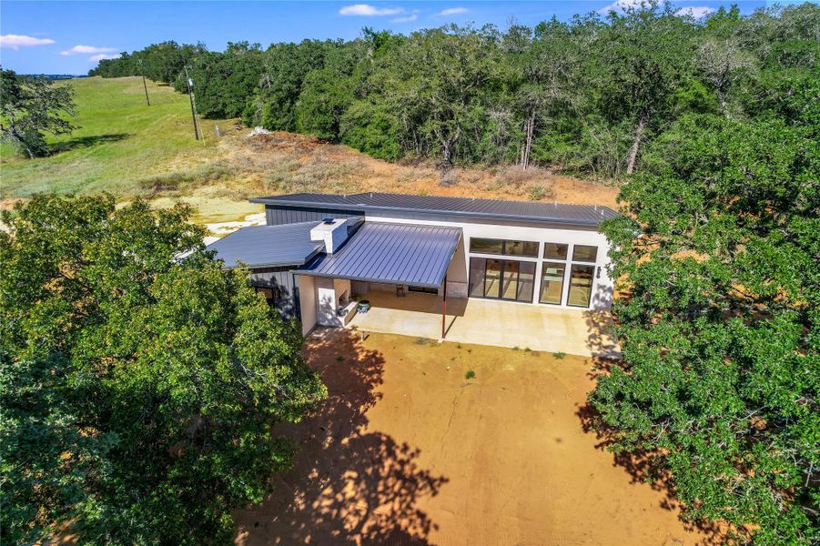 View of subject property with a forest