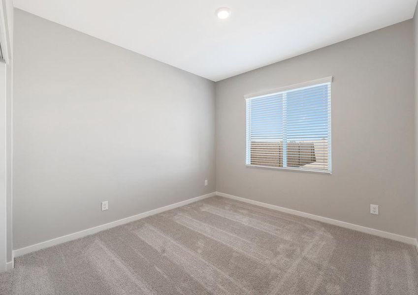 Secondary bedroom with recessed lighting and large windows.