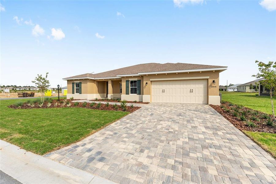 Front exterior of a new home in On Top of the World Communities, Ocala, FL, highlighting curb appeal (Image 1).