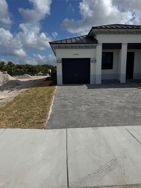Front exterior of a new home in , Homestead, FL, highlighting curb appeal (Image 7). Front exterior of a new home in , Homestead, FL, highlighting curb appeal (Image 7).