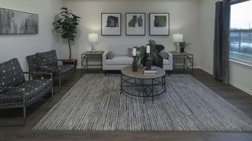Spacious living area featuring dark wood-finish flooring Spacious living area featuring dark wood-finish flooring