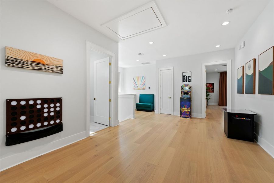 Designed with versatility in mind, this spacious upper-level flex room easily adapts as a game room, media lounge, home office, or additional gathering space, all finished with wide-plank hardwood flooring and recessed lighting. Designed with versatility in mind, this spacious upper-level flex room easily adapts as a game room, media lounge, home office, or additional gathering space, all finished with wide-plank hardwood flooring and recessed lighting.