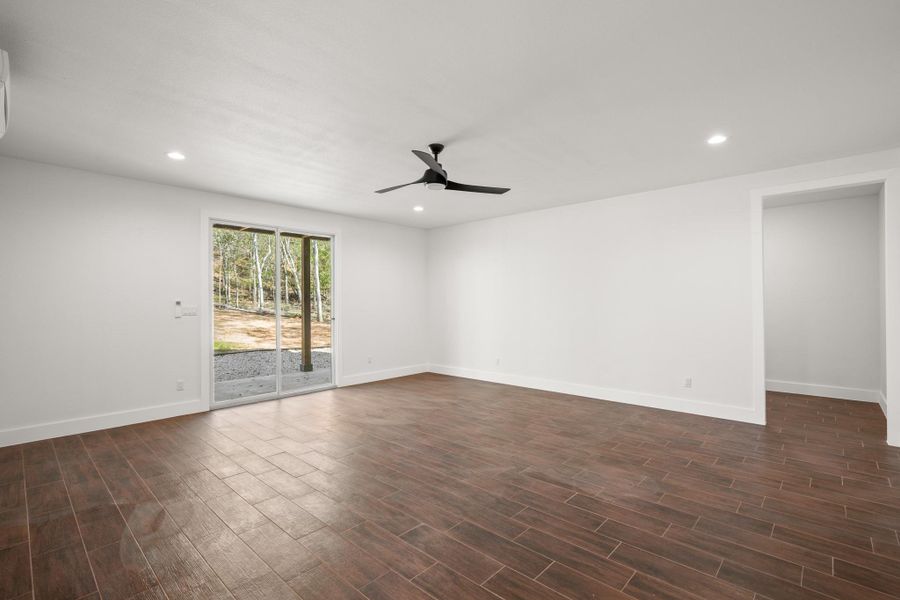 Empty room featuring recessed lighting, dark wood-style flooring, and a ceiling fan