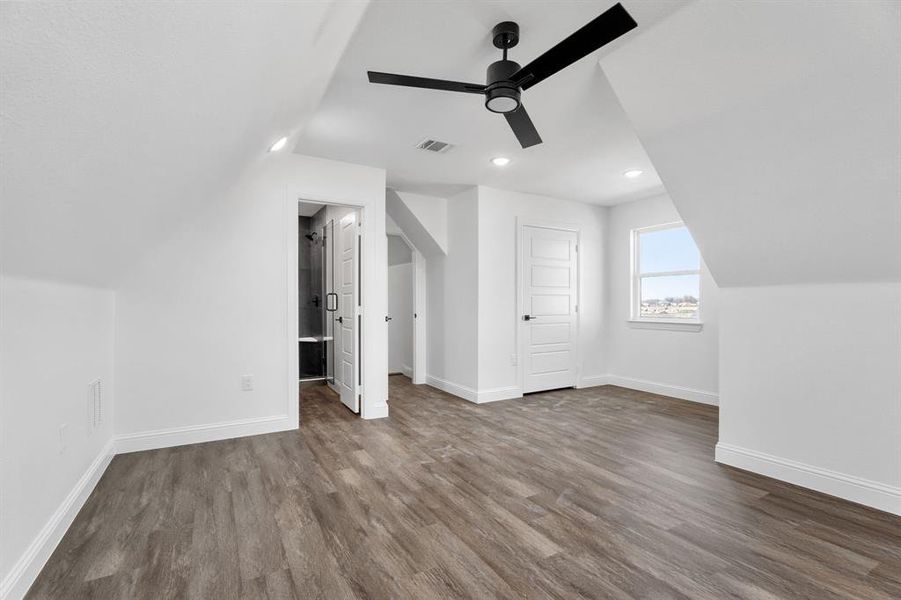 Bonus room featuring vaulted ceiling, ceiling fan, and hardwood / wood-style floors