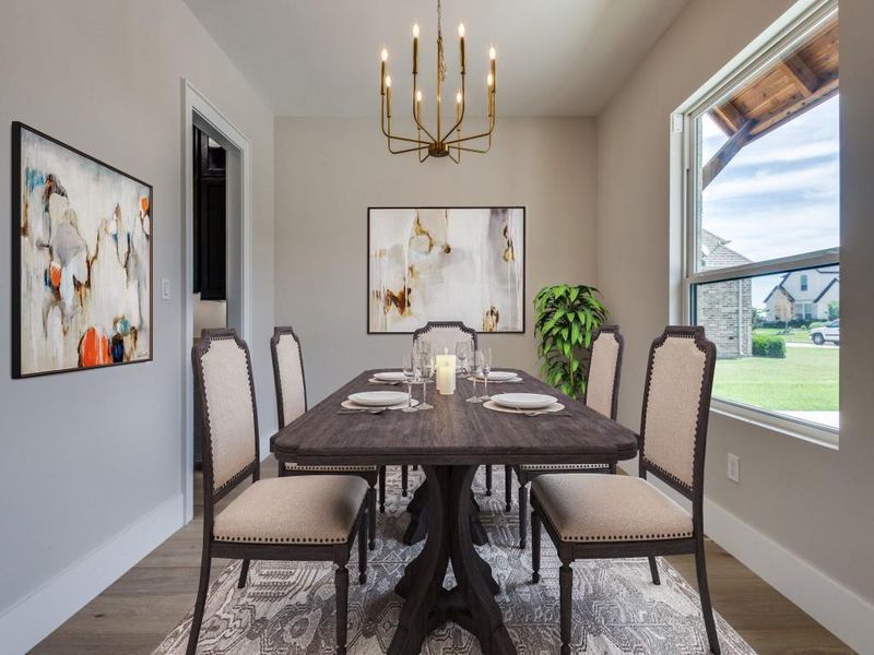 Dining space featuring a chandelier, wood finished floors, and baseboards with Virtual Staging