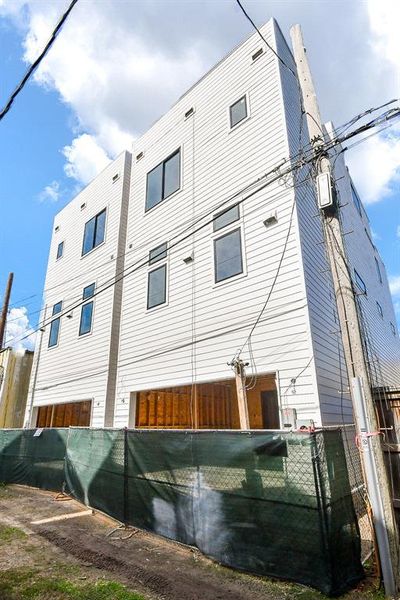 Back elevation with garage doors at Allely.