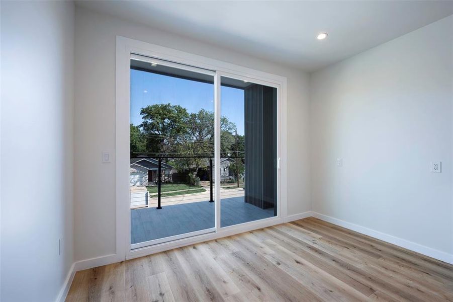 Sitting Room featuring light hardwood / wood-style floors and entry to second story balcony