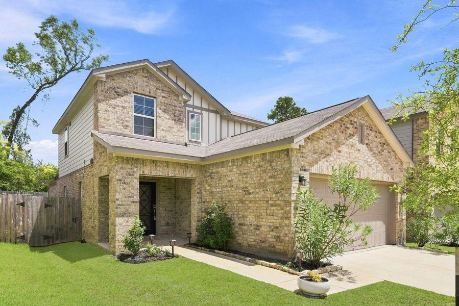 Front exterior of a new home in Lakes at Black Oak, Magnolia, TX, highlighting curb appeal (Image 1). Front exterior of a new home in Lakes at Black Oak, Magnolia, TX, highlighting curb appeal (Image 1).