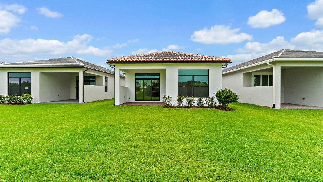 Front exterior of a new home in Rivella, Port St. Lucie, FL, highlighting curb appeal (Image 2).