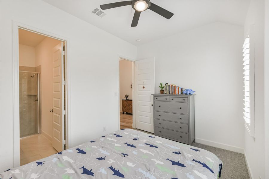 Front secondary bedroom has plantation shutters, fan, and ensuite bath. Front secondary bedroom has plantation shutters, fan, and ensuite bath.