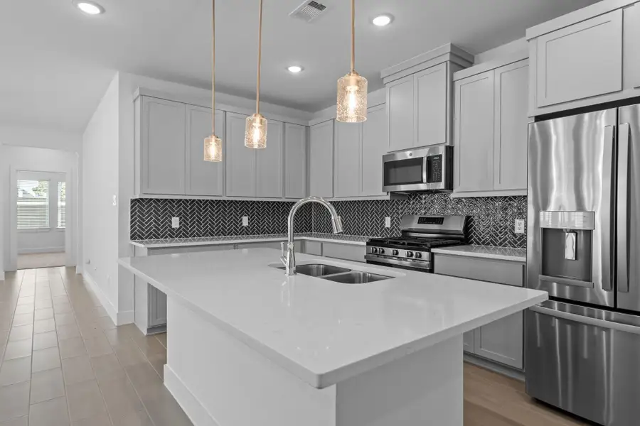 Furnished interior view inside a new home in Meridiana, Iowa Colony (Image 9).