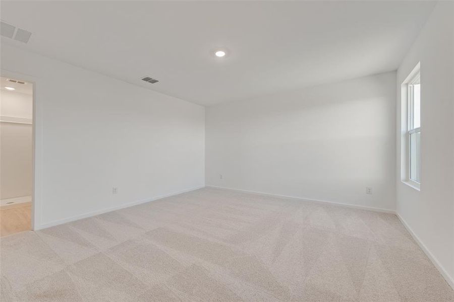 Unfurnished room featuring light carpet