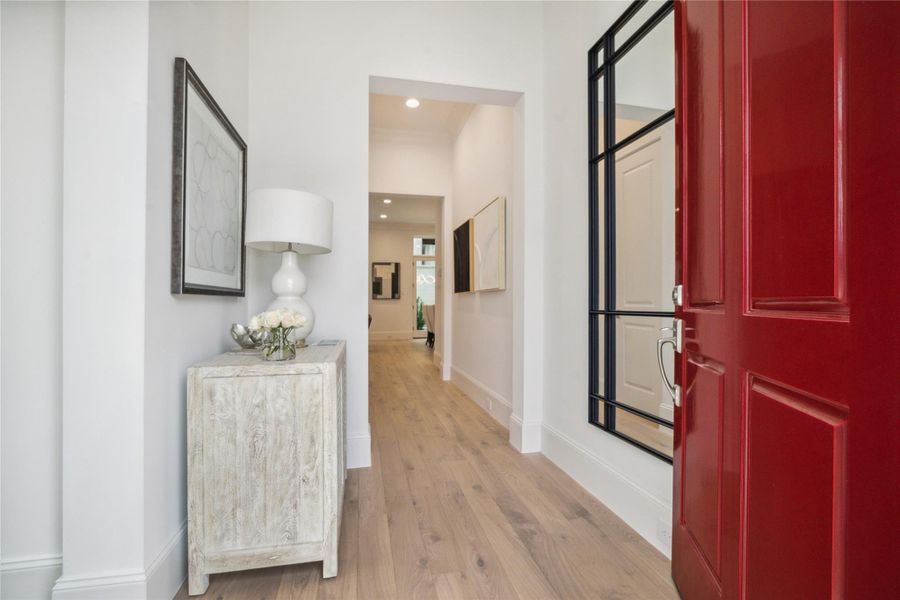 Step into this bright and welcoming formal entry. The first floor living space features 11-foot ceilings, Legno Bastone engineered White Oak wood floors, and designer light fixtures. Step into this bright and welcoming formal entry. The first floor living space features 11-foot ceilings, Legno Bastone engineered White Oak wood floors, and designer light fixtures.