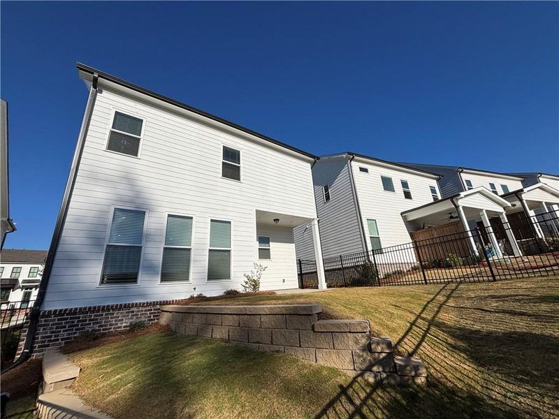 Exterior details and patio area of a home in Palisades Single Family, Cumming (Image 24).