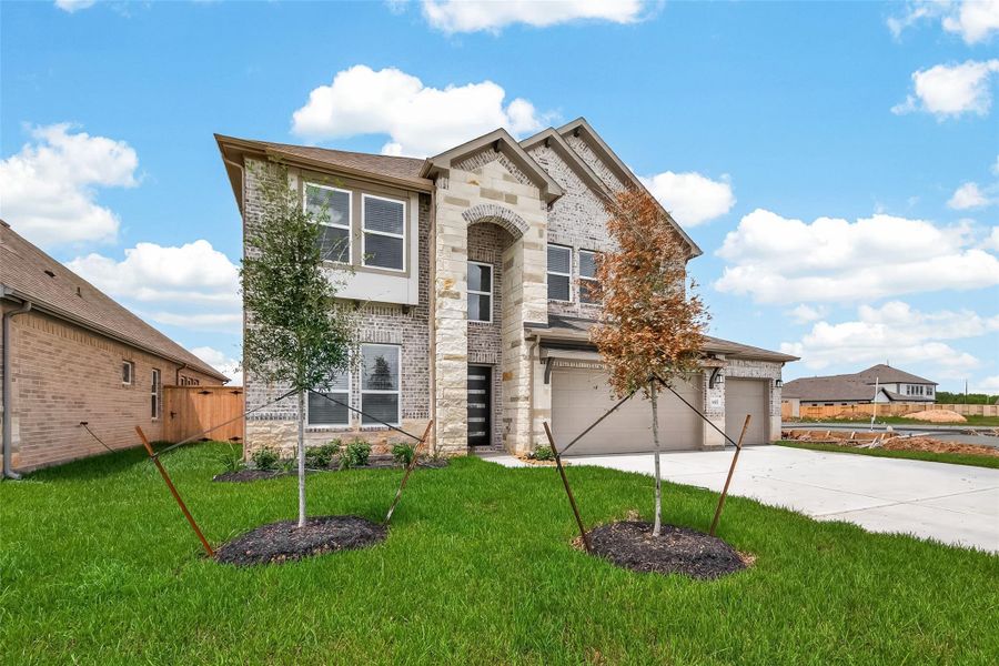 Front exterior of a new home in Foxtail Palms, Manvel, TX, highlighting curb appeal (Image 22). Front exterior of a new home in Foxtail Palms, Manvel, TX, highlighting curb appeal (Image 22).