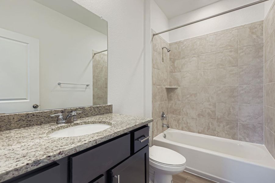 Full bath featuring shower combination and vanity Full bath featuring shower combination and vanity