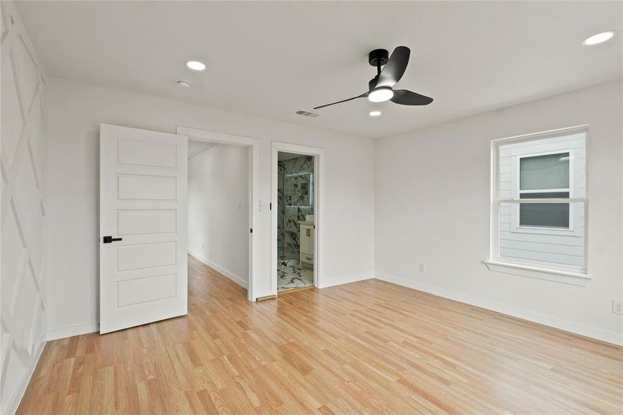 Spare room with ceiling fan and light wood-type flooring