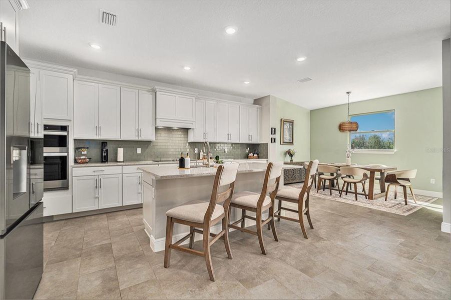 Very inviting kitchen! Tons of cabinets, stainless steel appliances