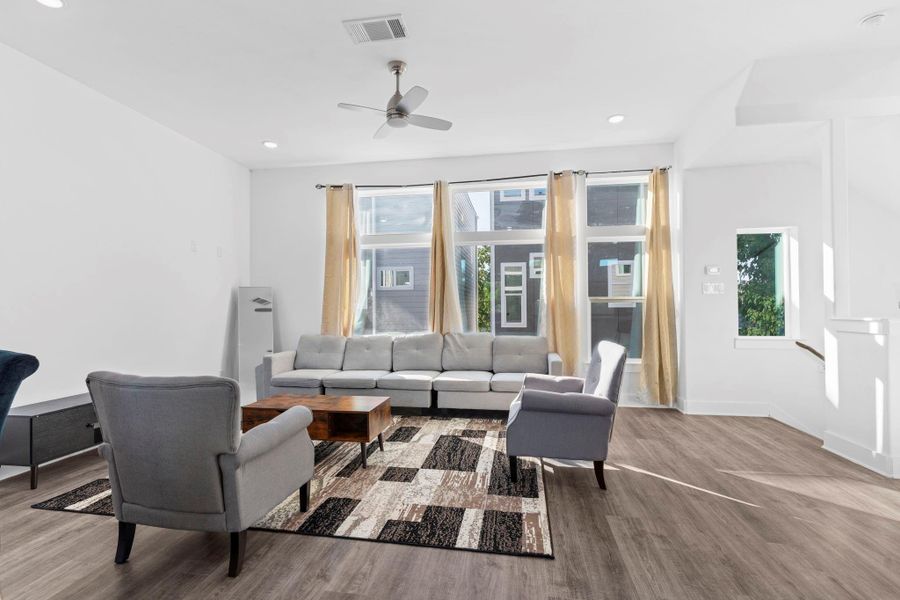 Open living area with large windows and a warm, inviting feel. Open living area with large windows and a warm, inviting feel.