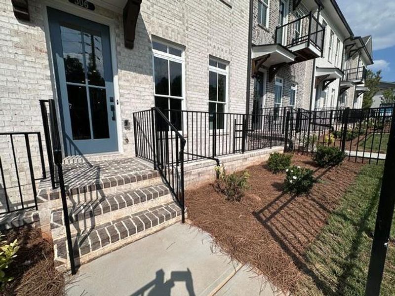 Exterior details and patio area of a home in Ward's Crossing Townhomes, Johns Creek (Image 22).