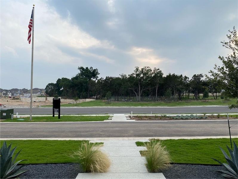 Semi-private slip street in front of house, with nature preserve view across the street.