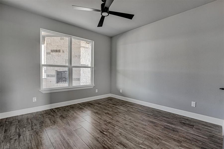 Spare room featuring ceiling fan and dark hardwood / wood-style floors