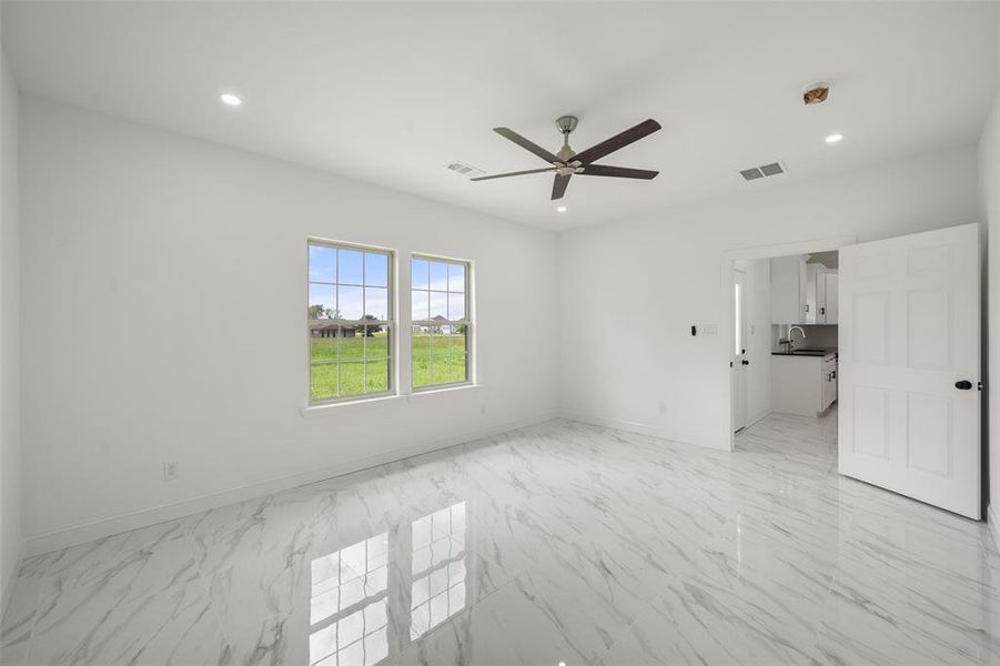 Spare room featuring a ceiling fan, light marble finish floors, and recessed lighting Spare room featuring a ceiling fan, light marble finish floors, and recessed lighting