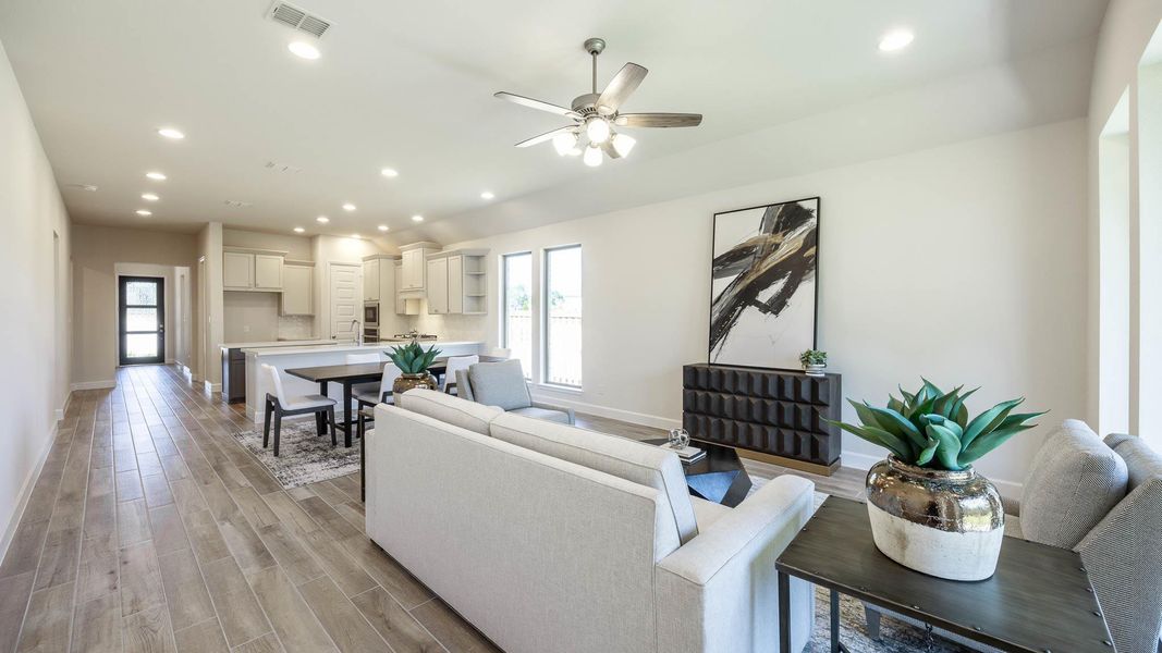 Living room with recessed lighting, light wood-style flooring, healthy amount of natural light, and ceiling fan Living room with recessed lighting, light wood-style flooring, healthy amount of natural light, and ceiling fan