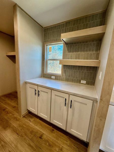 Detailed view of wood finished floors and decorative backsplash Detailed view of wood finished floors and decorative backsplash