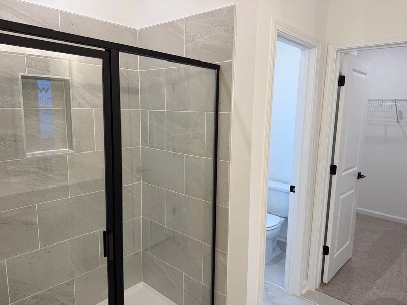 Primary Walk-In featuring the AW Collection® Serene - Open storage with understated design. Primary Walk-In featuring the AW Collection® Serene - Open storage with understated design.