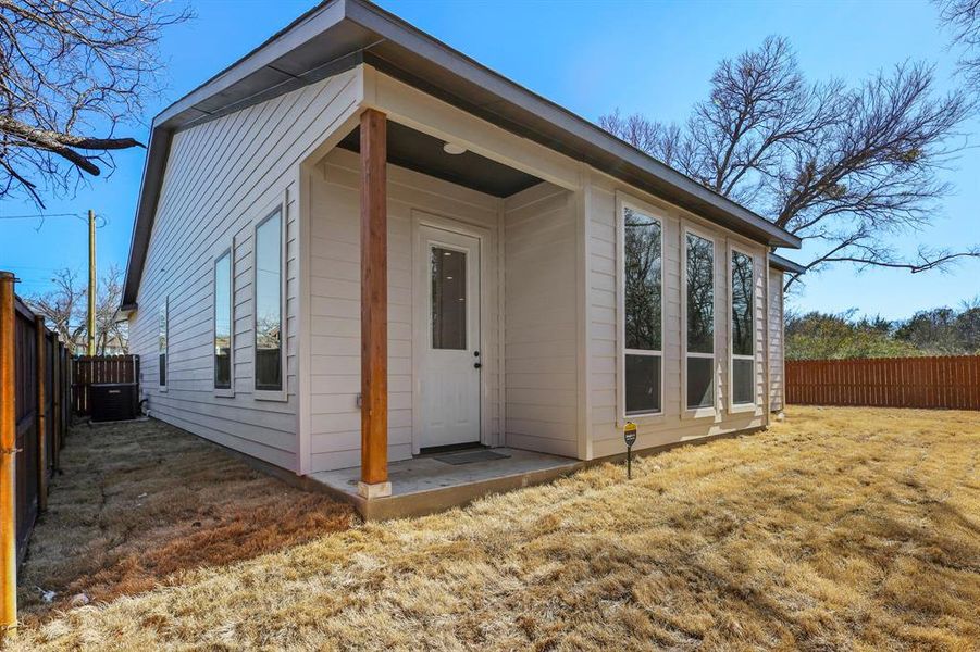 View of outdoor structure with cooling unit and a fenced backyard