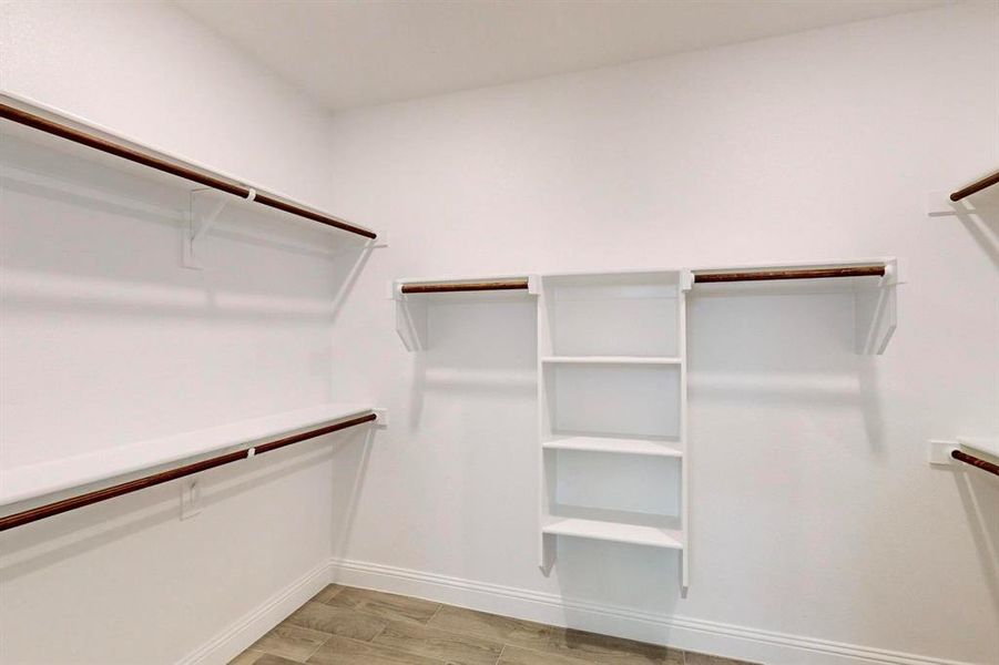 Main Walk in closet featuring light hardwood / wood-style floors