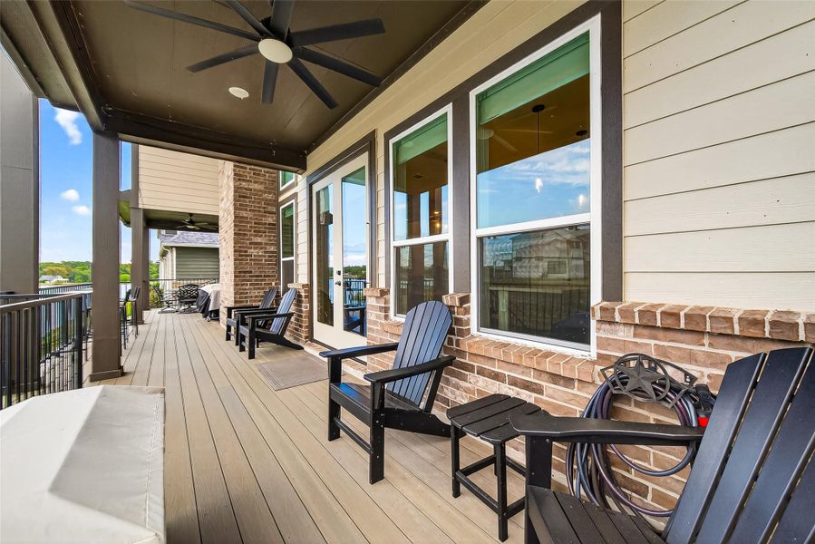 Spacious covered patio with composite decking, ceiling fan, and seating area. Enjoy beautiful lake views and evening breezes, perfect for entertaining or relaxing outdoors. Spacious covered patio with composite decking, ceiling fan, and seating area. Enjoy beautiful lake views and evening breezes, perfect for entertaining or relaxing outdoors.