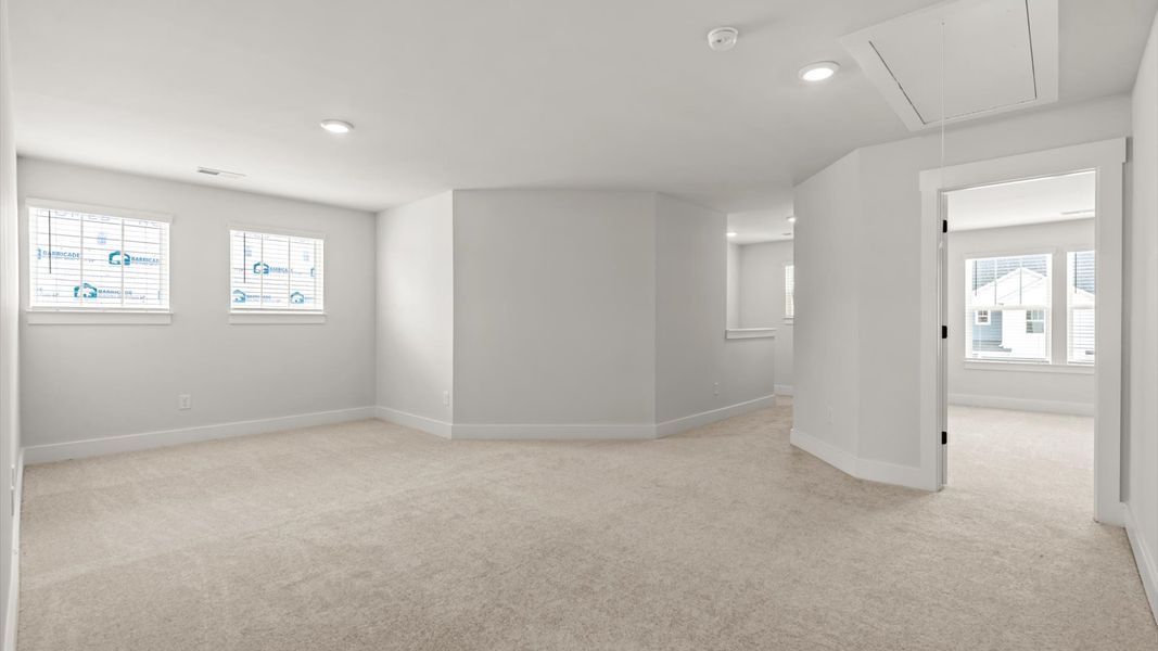 Memorable upstairs loft with plush carpeting and a bright, welcoming atmosphere