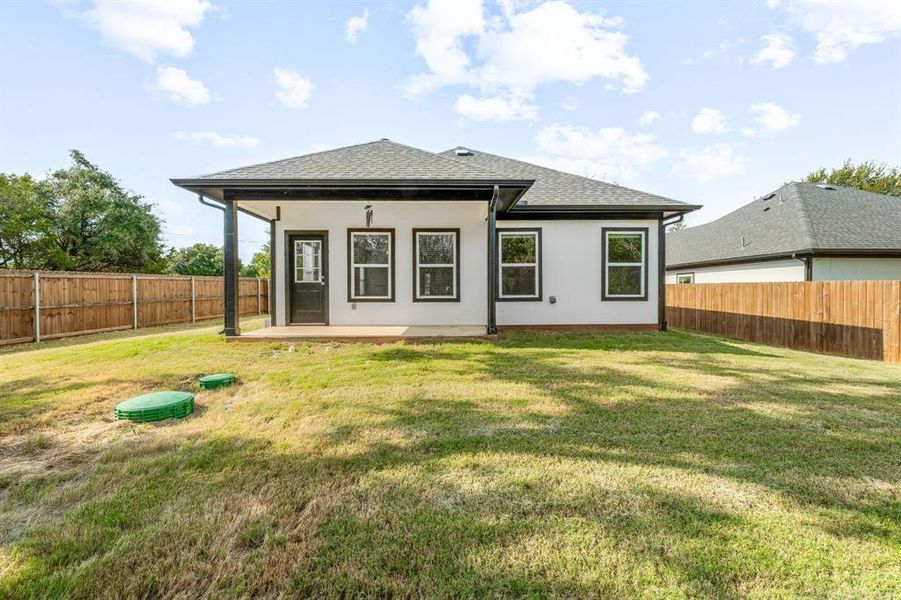 Rear view of house featuring a patio area, roof with shingles, a fenced backyard, and stucco siding Rear view of house featuring a patio area, roof with shingles, a fenced backyard, and stucco siding