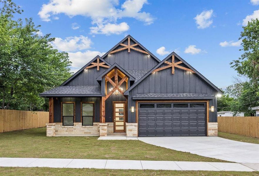 Craftsman-style exterior featuring dark vertical siding and stone accents Craftsman-style exterior featuring dark vertical siding and stone accents