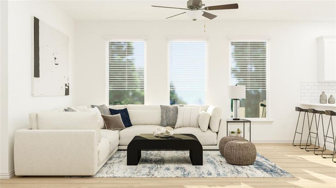 Living room with ceiling fan and light hardwood / wood-style flooring