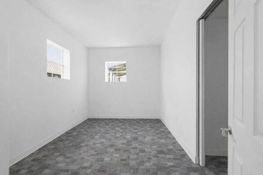 This interior room features white walls, two windows, and patterned grey flooring