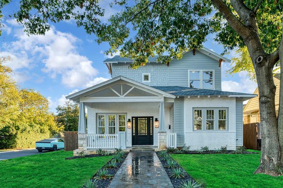 View of front facade with a front yard and a porch