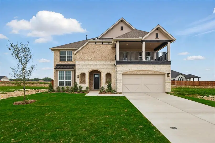 View of front facade with a balcony, a garage, driveway, stone siding, and a shingled roof View of front facade with a balcony, a garage, driveway, stone siding, and a shingled roof
