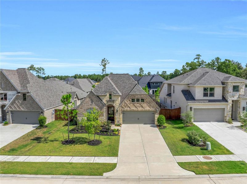 Welcome home to 15991 Mahogany Mist in the Evergreen community. A beautiful aerial perspective of the home’s attractive front elevation, showcasing its welcoming curb appeal and setting within the community.